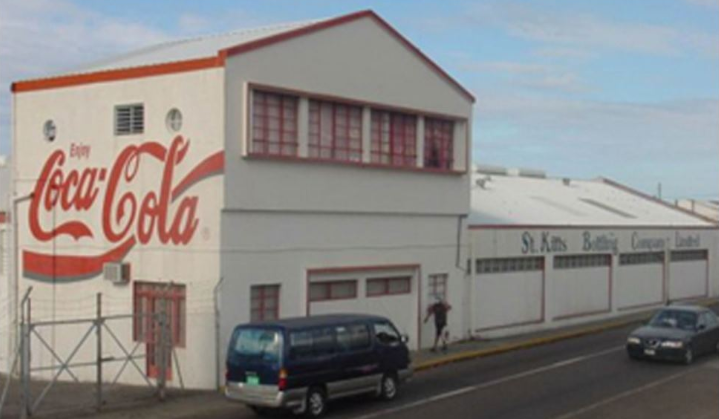 Street view of St. Kitts Bottling Company building with Coca Cola on the side.