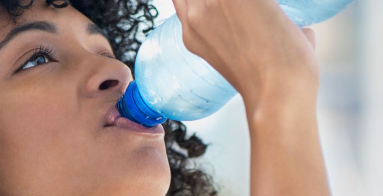 St. Kitts Bottling Company Ltd. A woman drinking water.