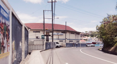 Grenada Postal Corporation building in view at the bend in the road.