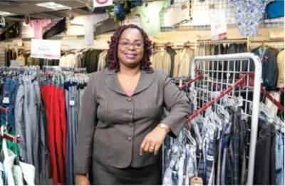 Abed & Company store with a woman standing for the camera with clothing racks around her.