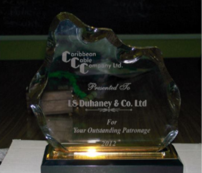 Caribbean Cable Company Ltd glass plaque that says Presented To LS Duhaney & Co. Ltd For Your Outstanding Patronage 2012.