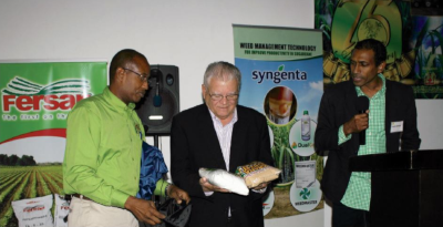 The Honorable Karl Samuda, Minister to the Ministry of Industry, Commerce, Agriculture and Fisheries Jamaica meets with business people at a conference.