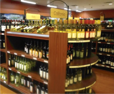 Roadtown Wholesale Trading Ltd, a view of the wine section inside of a store, showing multiple shelves of wine to choose from.