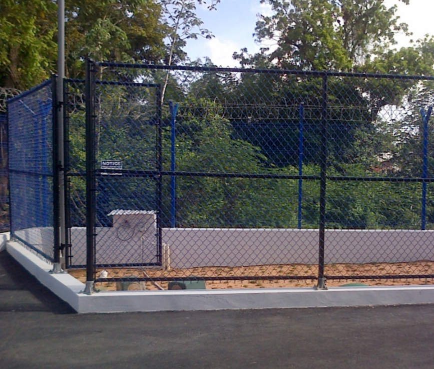 A fence around a grassy area, with the gate/door open.