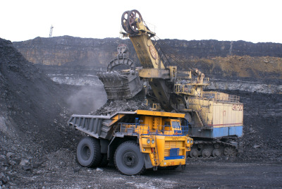 Lydford Mining. A dump truck and excavator working in a pit.