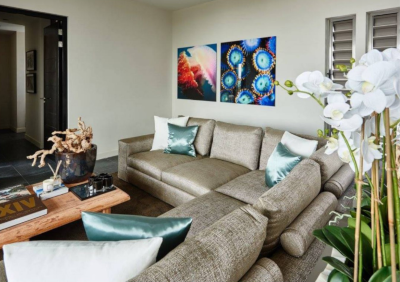 Aquarius Caribbean. Interior view of a house with a corner sofa, coffee table and decorations.