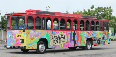 Autobusbedrijf Curaçao's colorful parandabus parked in a parking lot.