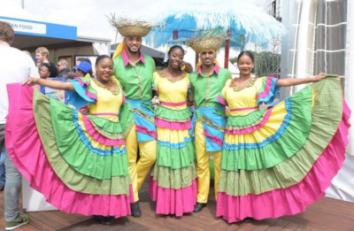 Colorfully dressed men and women pose for a photo.