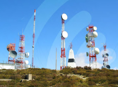 The Spectrum Management Authority of Jamaica. Metal towers with communications equipment on a hillside.