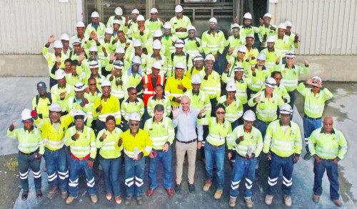 Arawak Cement Company Ltd Barbados group shot of employees in yellow safety gear.