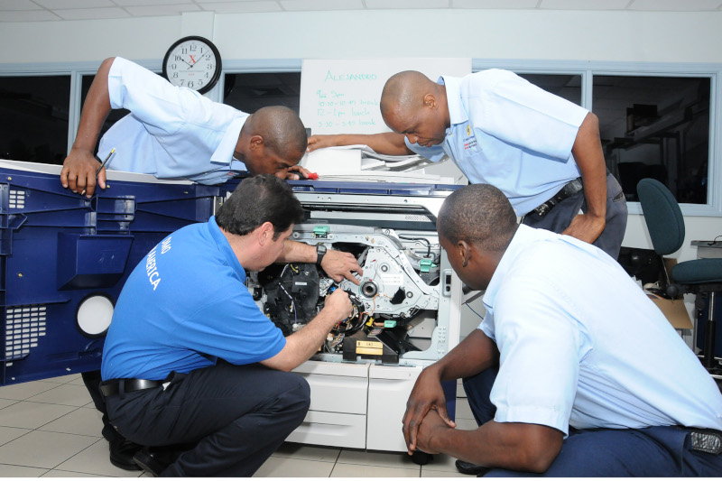 J.E. Bergasse & Company Ltd. service team in action working on a copier.