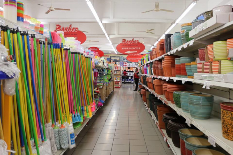 Bashco Trading Company isle showing cleaning supplies on the left and pots for plants on the right.