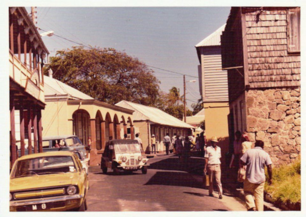 M.S. Osborne Ltd. old photo of the street with cars on the street and people going about their day.