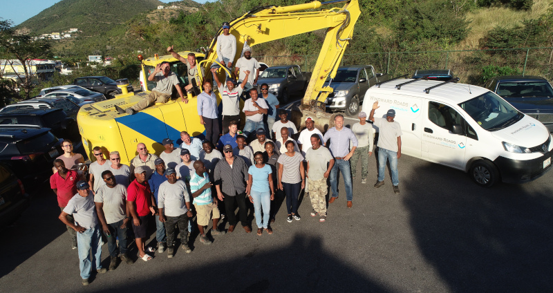 Winward Roads Infrastructure group photo of employees on and around an excavator.