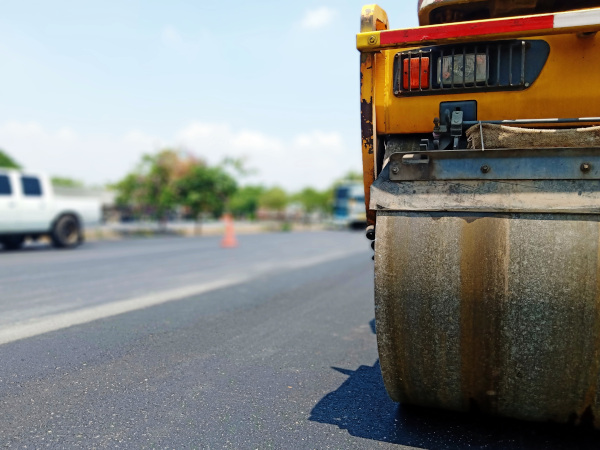 Virgin Islands Paving Inc. stock image of a steam roller working on a road.