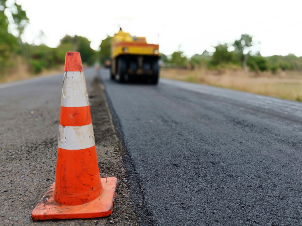 Virgin Islands Paving Inc. stock image of a steam roller working on a road.