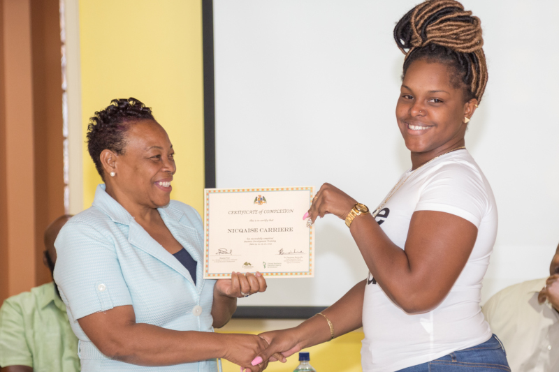 Ministry of Commerce, Enterprise and Small Business Development - Dominica; The Honorable Minister Paul gives out a completion certificate at a Small Business Training event.