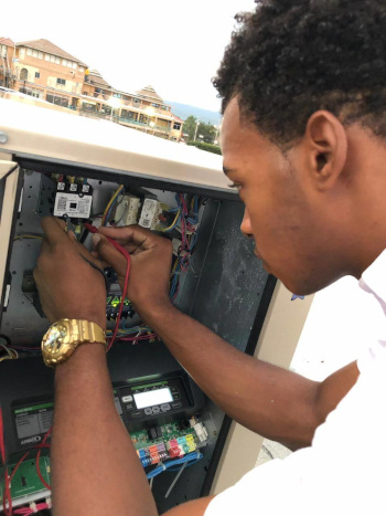 Geddes Refrigeration Ltd employee working on electrical components in a box.