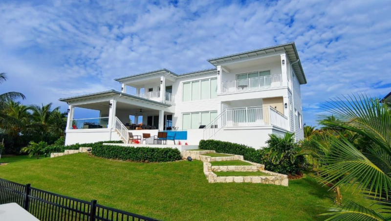 Edgewater Development Ltd example of work showing the front of a house with green grass and blue sky with white puffy clouds scattered