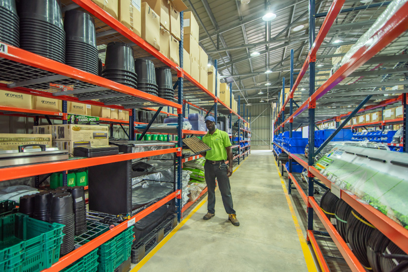 Isratech Jamaica IJL Retail Store interior with an employee holding an item.