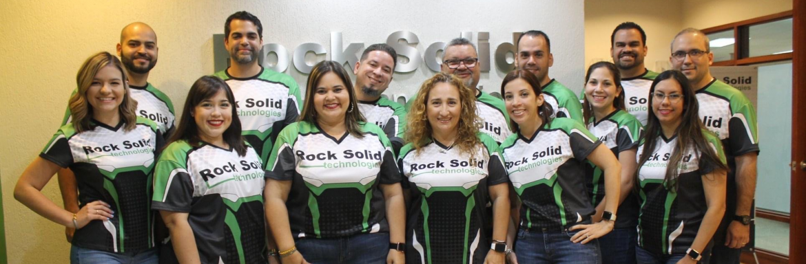 Rock Solid Technologies Puerto Rico group photo of employees wearing company shirts.